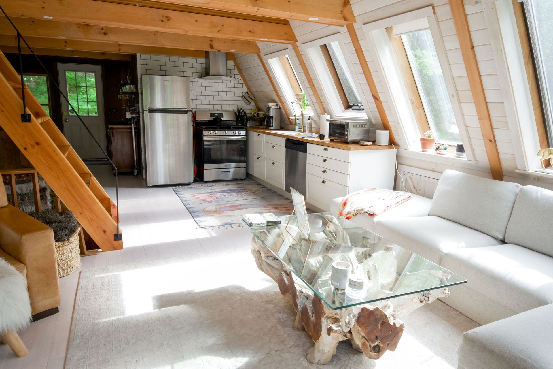 Cozy A-frame cabin interior featuring modern furnishings and natural light.